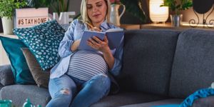 heavily-pregnant-woman-writing-a-list-of-things-she-needs-to-bring-to-picture-id1268591743.jpg