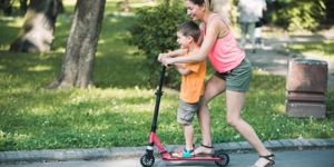 little-boy-riding-a-push-scooter-with-his-mom-picture-id1157661176.jpg