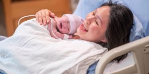 asian-mother-having-skintoskin-time-in-the-delivery-room-stock-photo-picture-id1193360575.jpg