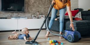 mum vacuuming with baby