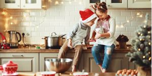 happy-children-boy-and-girl-bake-christmas-cookies-picture-id1189805442 (1).jpg