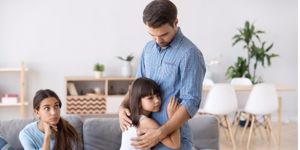 unhappy-family-in-living-room-daughter-embrace-father-picture-id1070262136.jpg