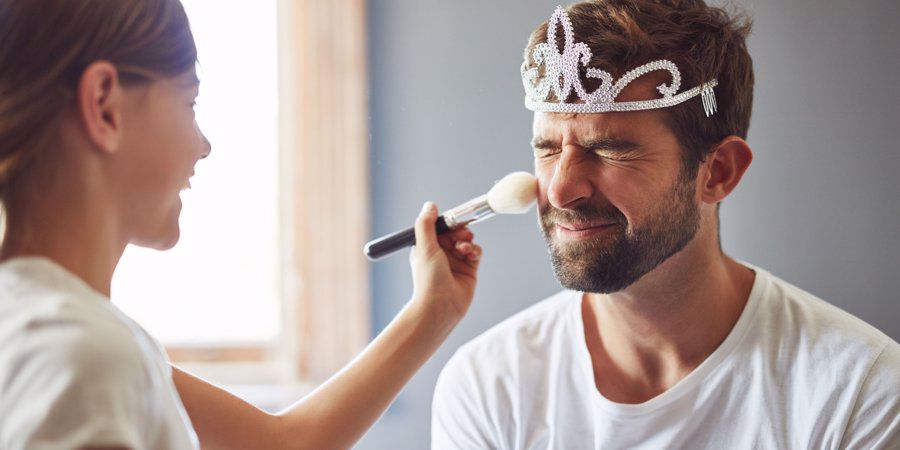 daughter putting makeup on dad