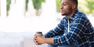 portrait-of-pensive-african-american-guy-sitting-with-coffee-picture-id1264246859.jpg