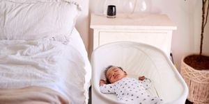 Baby in bedside crib sleeping