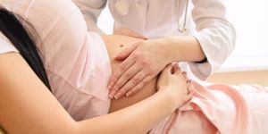 doctor-touch-pregnant-tummy-with-hands-picture-id922691860.jpg