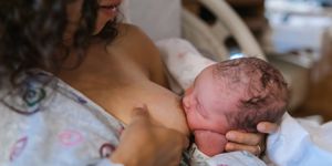 mother breastfeeding their newborn in hospital