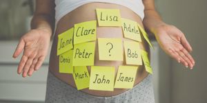 toned-shot-of-pregnant-woman-with-child-names-on-belly-picture-id615637828.jpg
