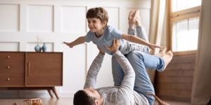 joyful-young-man-father-lifting-excited-happy-little-son-picture-id1206859193.jpg
