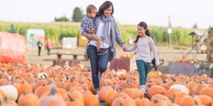beautiful-ethnic-mom-and-her-daughters-at-the-pumpkin-farm-picture-id971833110.jpg
