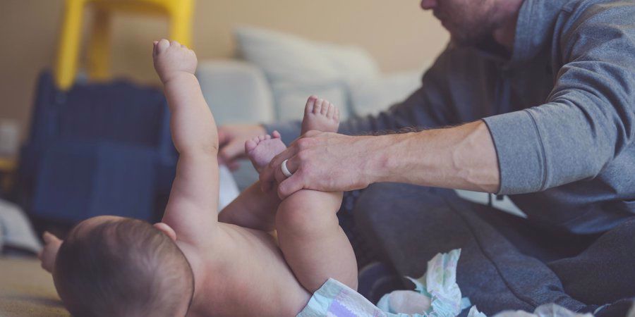 dad changing baby's diaper