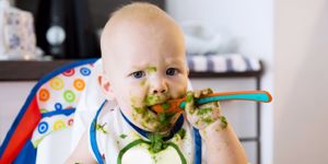 weaning baby eating green food