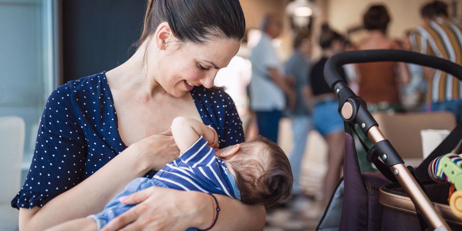 mum breastfeeding baby in cafe