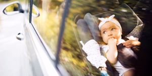 baby in carseat car motoring