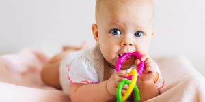 baby-girl-with-teething-ring-picture-id624908368.jpg