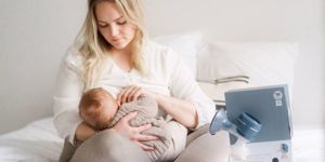 mum breastfeeding baby with pump