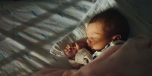 newborn baby sleeping under blanket
