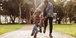 father-teaching-his-son-cycling-at-park-picture-id1126785367.jpg