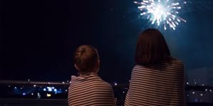 mother-and-son-looking-at-new-year-celebration-fireworks-in-night-sky-picture-id1176312574.jpg