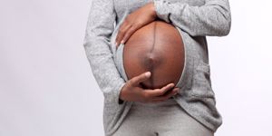 pregnant mom holding bump