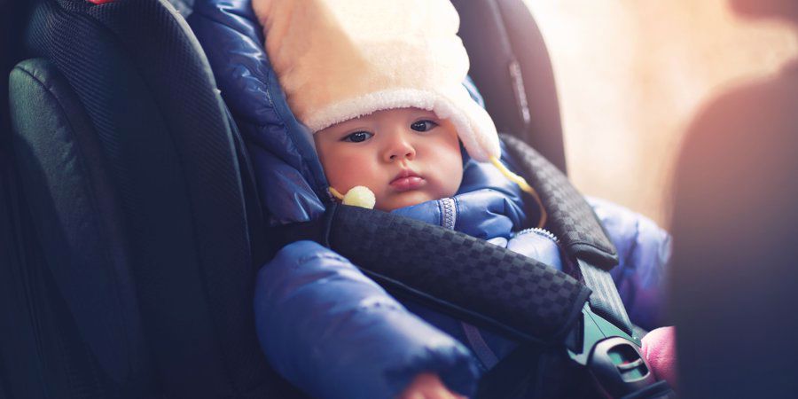 baby wrapped warm in car seat