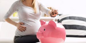 pregnant mom saving in piggy bank