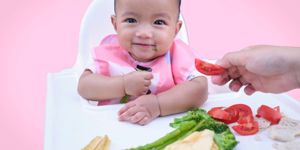 baby in high chair with weaning foods