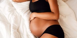 Pregnant woman holding stomach