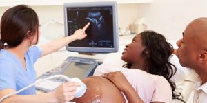 pregnant-woman-and-partner-having-4d-ultrasound-scan-picture-id457162975.jpg