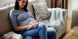 pregnant-woman-making-notes-picture-id1197693684.jpg