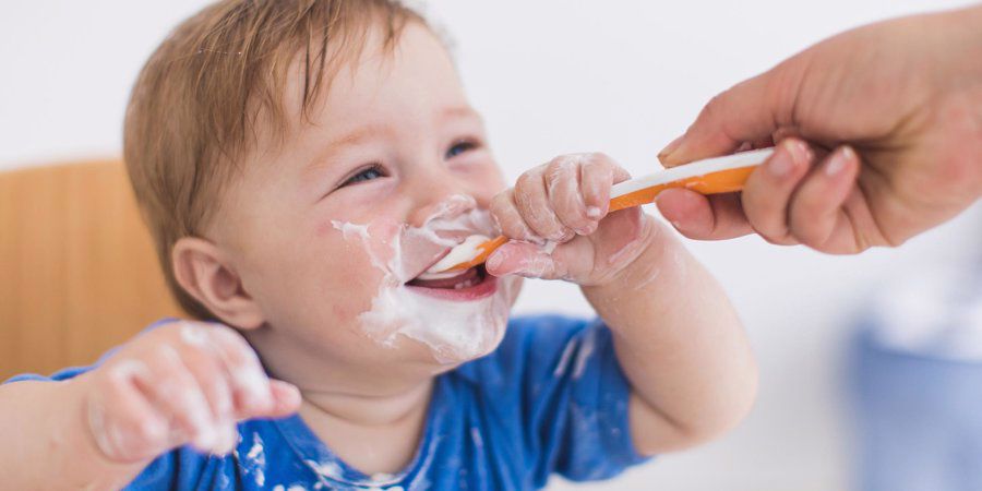 baby eating yoghurt