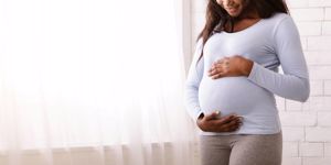 afro-woman-enjoying-her-pregnancy-hugging-her-tummy-picture-id1199663087.jpg