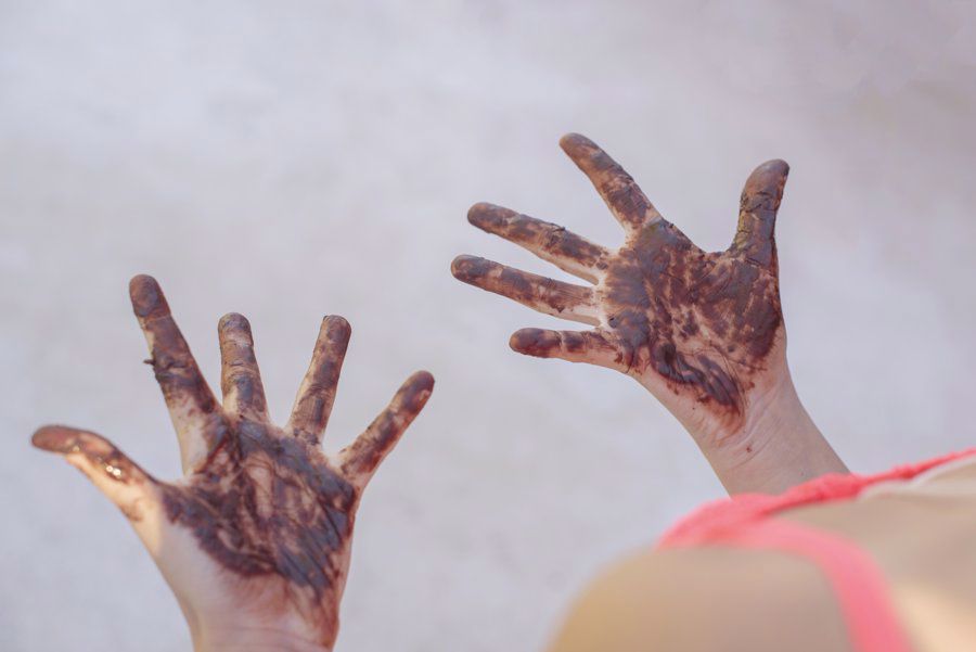 Child with chocolate on their hands