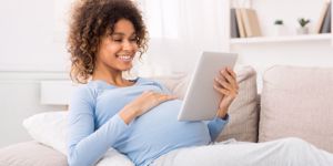 relaxed-pregnant-girl-using-tablet-browsing-internet-picture-id1190581115.jpg