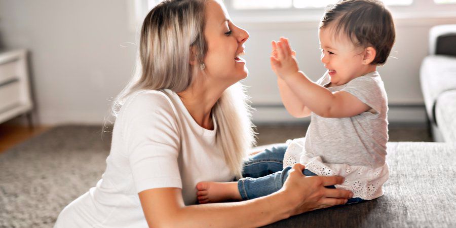 mother playing with baby