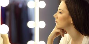 woman looking in the mirror at herself