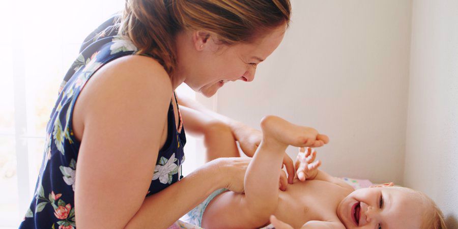 mom changing baby's diaper