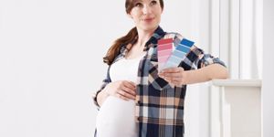 pregnant-woman-choosing-color-scheme-fort-babys-room-picture-id518060002.jpg