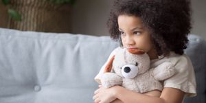 upset-lonely-african-kid-girl-holding-teddy-bear-looking-away-picture-id1135353604.jpg