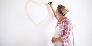 expectant-mother-painting-a-heart-picture-id184648619.jpg