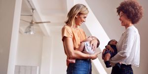 two-mothers-meeting-holding-newborn-babies-at-home-in-loft-apartment-picture-id1153668185.jpg