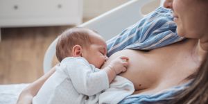 a woman in hospital breastfeeding her baby 