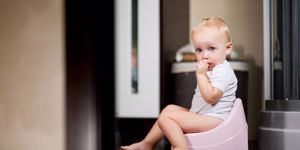 little-girl-sits-on-a-pot-in-the-bathroom-and-looks-in-surprise-picture-id1190927684.jpg