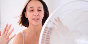 woman cooling down by a fan