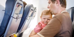 dad on plane with crying baby