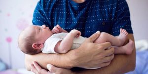 close-up-of-unrecognizable-father-holding-his-newborn-baby-son-picture-id629611996.jpg