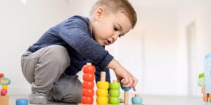 small-boy-playing-with-little-wood-toys-at-home-on-the-floor-learning-picture-id1150167434.jpg
