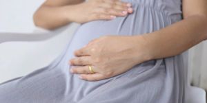 pregnant-women-put-his-hand-on-her-belly-picture-id495839022.jpg