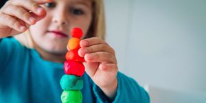 baby stacking balls of play-doh
