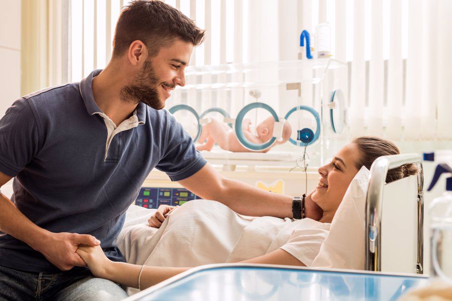 birth partner with new mum in hospital